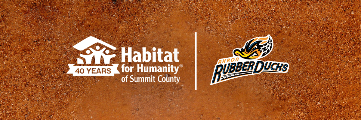 Habitat for Humanity of Summit County 40 Years logo alongside the Akron RubberDucks logo, separated by a vertical line over a baseball infield dirt background.